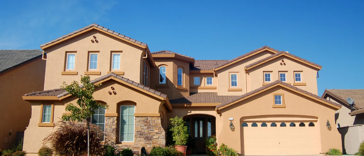 Before exterior remodeling project in Los Angeles showing outdated stucco facade, old windows, and traditional design