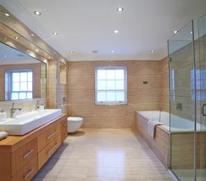 Luxury bathroom remodeling project in Los Angeles with walk-in glass shower, soaking tub, and modern tile design