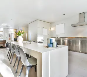 Modern kitchen remodeling project in Los Angeles with white cabinets, open layout, large island, and contemporary finishes