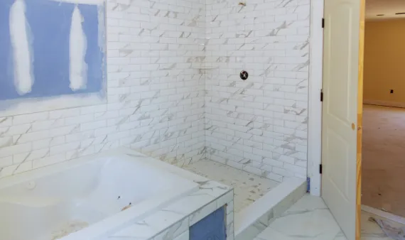 Bathroom remodeling in Los Angeles featuring marble shower installation and bathtub upgrade in progress